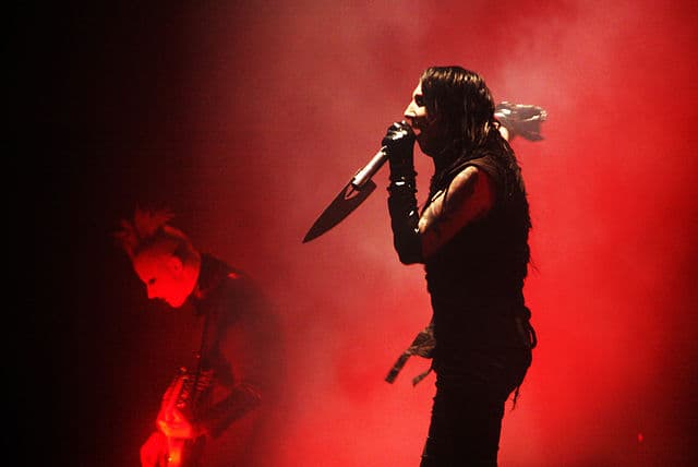 Marilyn Manson live concert photo from 2007 Eat Me, Drink Me era with gothic red lighting and emotional stage performance.