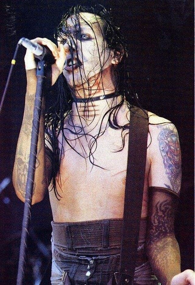 Marilyn Manson performing live during the Antichrist Superstar tour, wearing dark theatrical makeup and gothic stage attire.